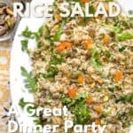 Oval platter topped with rice and quinoa salad with chopped apricots, pistachios and arugula.