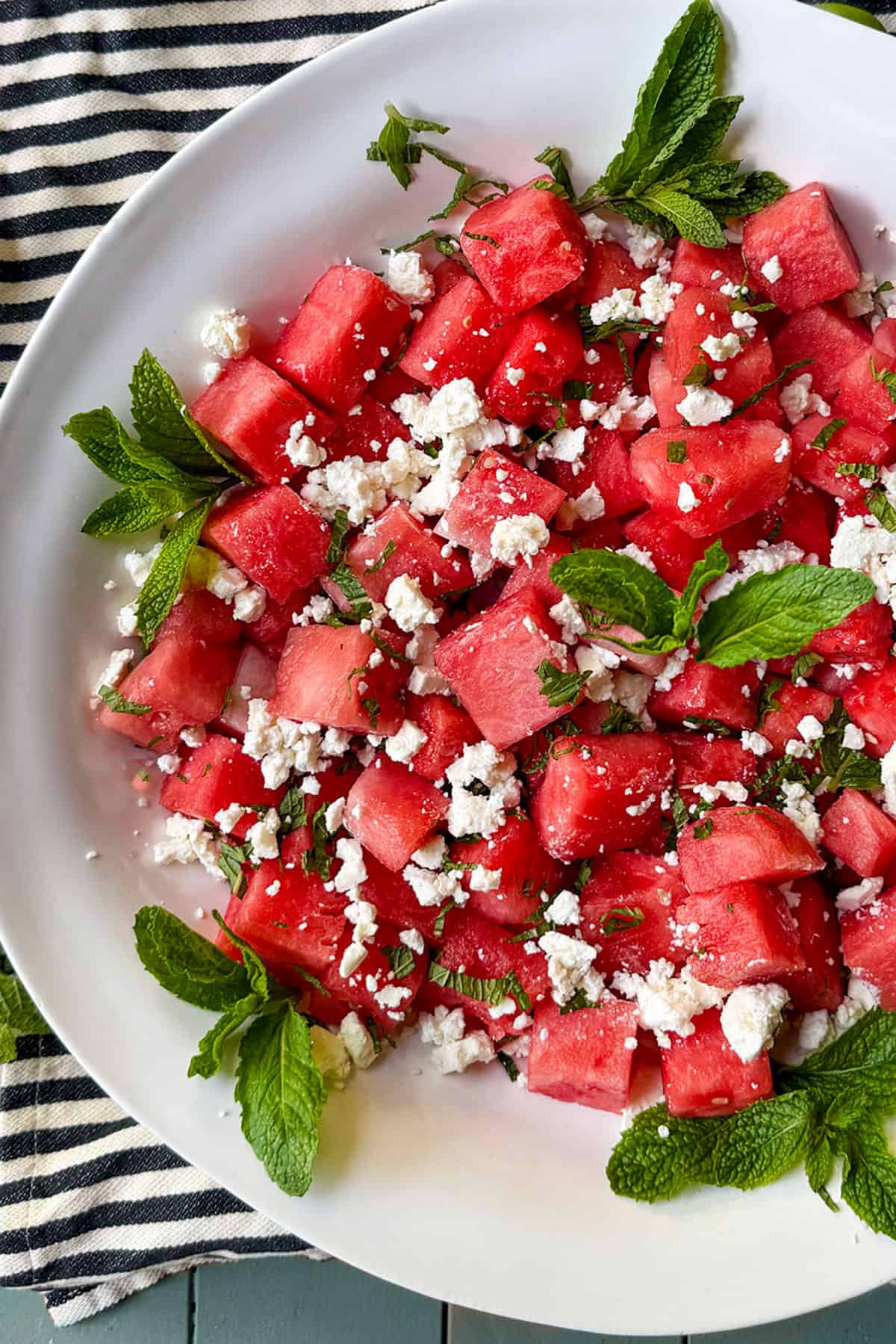 watermelon salad with mint and feta in a large shallow serving bowl.