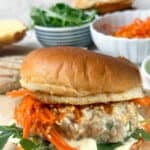 ahi tuna burger on a brioche bun with Kewpie mayo, carrot slaw and arugula.
