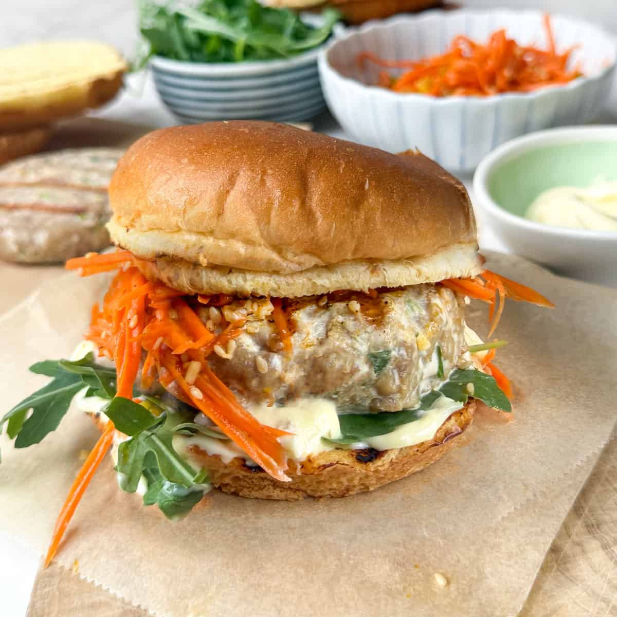 Ahi tuna burger with carrot slaw on a bun.