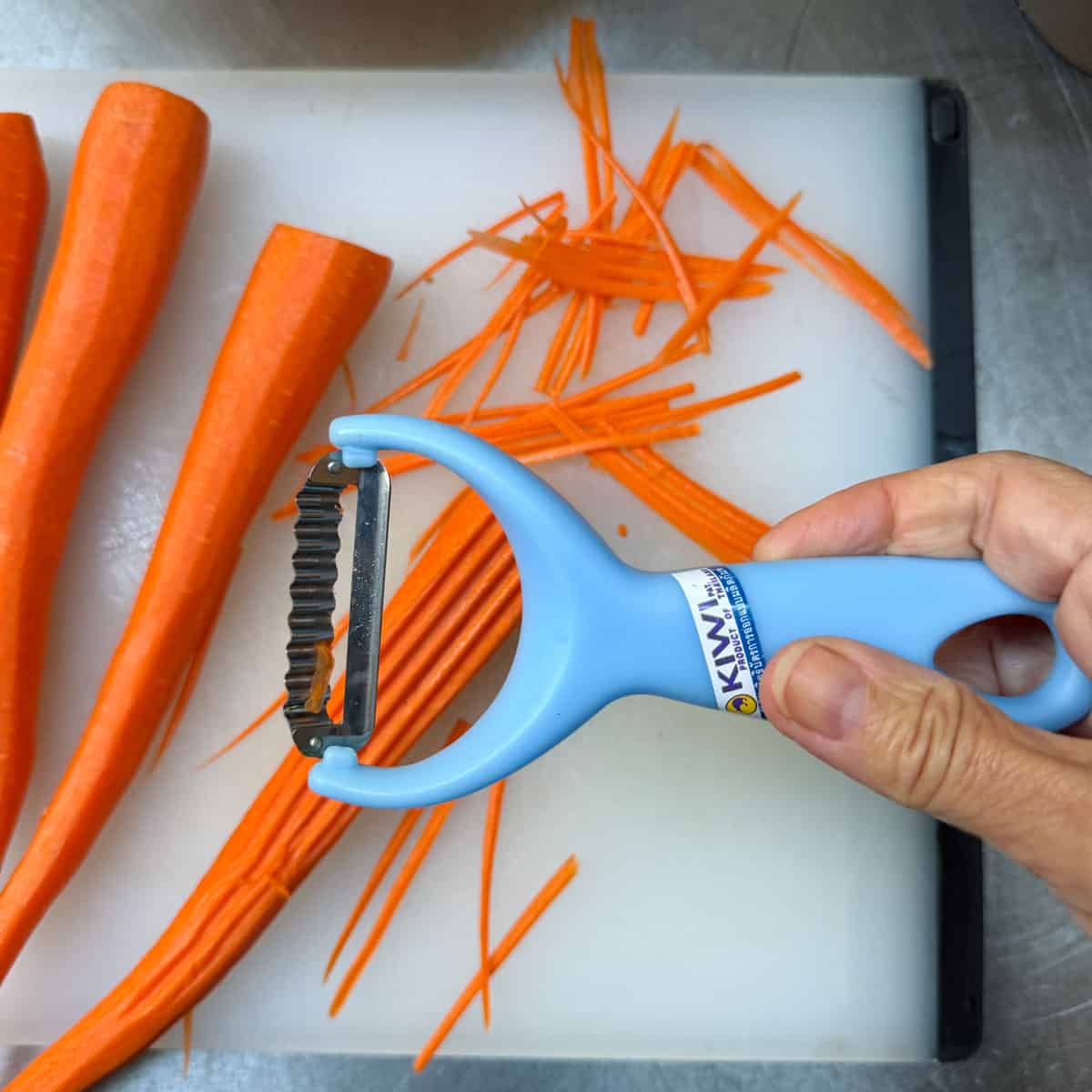 Shredding carrots using a Thai vegetable peeler
