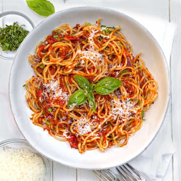 Bowl of spaghetti with roasted tomato sauce, parmesan and basil.