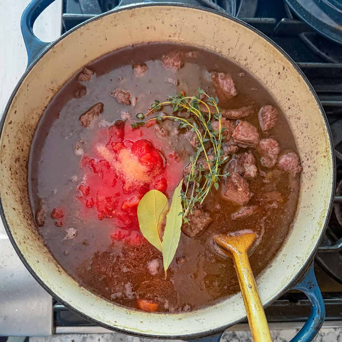 beef stew ingredient in a dutch oven.