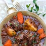 bowl of beef stew with potatoes and carrots.